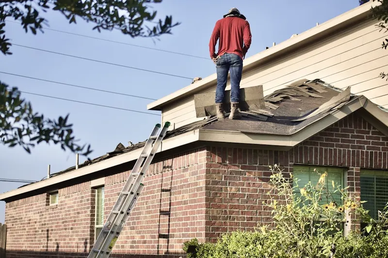 Professional roofer working on a residential roof in Downey